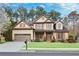 Charming two-story home with a well-maintained lawn, complemented by mature trees and attractive landscaping at 2964 Perimeter Cir, Buford, GA 30519