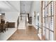 Bright foyer featuring hardwood floors, a staircase with white risers, and a view into the dining room at 2964 Perimeter Cir, Buford, GA 30519