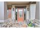 Elegant front entry with a stone porch, stylish door with sidelights, and decorative lantern-style lighting at 2964 Perimeter Cir, Buford, GA 30519