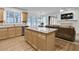 Open-concept kitchen with island and view of living room with fireplace at 2964 Perimeter Cir, Buford, GA 30519