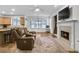 Open living room with hardwood floors, a fireplace, and a view of the kitchen at 2964 Perimeter Cir, Buford, GA 30519