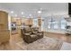 Open-concept space featuring a modern couch, wood floors, and a view into the gourmet kitchen at 2964 Perimeter Cir, Buford, GA 30519