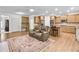 Open-concept living area featuring a cozy couch, hardwood floors, and a view into the kitchen at 2964 Perimeter Cir, Buford, GA 30519