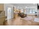 Open-concept living room with a cozy couch, wood flooring, and a view of the modern kitchen at 2964 Perimeter Cir, Buford, GA 30519