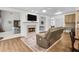 Well-lit living area with fireplace, wood floors, and open access to dining and kitchen at 2964 Perimeter Cir, Buford, GA 30519
