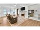 Bright living room featuring a fireplace, hardwood floors, and large windows at 2964 Perimeter Cir, Buford, GA 30519