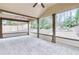 Inviting screened porch with views of the private backyard landscaping, perfect for outdoor relaxation and entertainment at 2964 Perimeter Cir, Buford, GA 30519