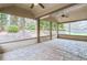 Charming screened porch with stamped concrete flooring, ceiling fans, and serene views of the landscaped backyard at 2964 Perimeter Cir, Buford, GA 30519