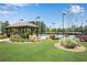 Community tennis courts with a covered gazebo, lush greenery, and well-maintained landscaping at 2964 Perimeter Cir, Buford, GA 30519