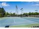 Well-maintained community tennis courts with pristine playing surfaces, overhead lighting, and secure fencing at 2964 Perimeter Cir, Buford, GA 30519