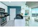 Bright kitchen showcasing stainless steel appliances, granite countertops, and a breakfast bar with seating at 361 17Th St # 2122, Atlanta, GA 30363