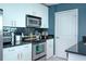 Contemporary kitchen with stainless steel oven and microwave, black subway tile backsplash, and white cabinetry at 361 17Th St # 2122, Atlanta, GA 30363