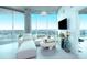 Bright living room with floor-to-ceiling windows showcasing a stunning city view, and white contemporary furniture at 361 17Th St # 2122, Atlanta, GA 30363