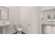 Bathroom featuring a pedestal sink, toilet, and view into the living area at 612 Kimberwick Dr, Locust Grove, GA 30248