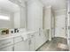 Bathroom featuring tiled floors, white cabinets and a black faucet at 906 Bingham St, Woodstock, GA 30188