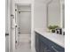 Bathroom with navy cabinets and tub/shower combo at 906 Bingham St, Woodstock, GA 30188