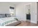 Serene bedroom featuring hardwood floors and ensuite bathroom entrance at 906 Bingham St, Woodstock, GA 30188