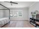 Bright bedroom featuring a four-poster bed, and a stylish display on a sleek black shelving unit at 906 Bingham St, Woodstock, GA 30188