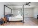 Spacious bedroom featuring a modern four-poster bed and natural light from three windows at 906 Bingham St, Woodstock, GA 30188