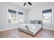 Bright bedroom featuring hardwood floors, neutral walls, large windows, and a comfortable bed with stylish bedding at 906 Bingham St, Woodstock, GA 30188