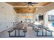 Indoor/outdoor community space with picnic tables, ceiling fans, and modern chandeliers at 906 Bingham St, Woodstock, GA 30188