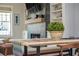 Bright dining area with a modern table, stylish bench seating, and views of the cozy fireplace at 906 Bingham St, Woodstock, GA 30188