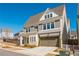 Beautiful two-story home with a two-car garage and a well-manicured lawn on a clear and sunny day at 906 Bingham St, Woodstock, GA 30188