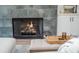 Close-up of the fireplace, highlighting the tiled surround, wooden mantel, and warm, inviting flames at 906 Bingham St, Woodstock, GA 30188