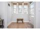 Bright foyer featuring hardwood floors, a rustic bench, natural light, and a cozy atmosphere for arriving guests at 906 Bingham St, Woodstock, GA 30188