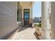 Welcoming front porch with decorative columns, a stylish front door, and beautiful landscaping, enhancing curb appeal at 906 Bingham St, Woodstock, GA 30188