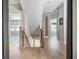 Hallway with staircase, light wood floors and natural lighting at 906 Bingham St, Woodstock, GA 30188