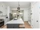 Kitchen with island and seating, stainless steel appliances, and white cabinets at 906 Bingham St, Woodstock, GA 30188