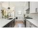 Well-lit kitchen with island, stainless steel appliances, and a view into the dining room at 906 Bingham St, Woodstock, GA 30188
