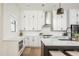 Bright, spacious kitchen featuring white cabinets, stainless steel appliances, and a large center island at 906 Bingham St, Woodstock, GA 30188