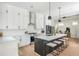 Open kitchen design with island seating, modern pendant lights, and stainless steel appliances at 906 Bingham St, Woodstock, GA 30188