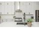 Close-up of kitchen details: stainless steel stove, white tile backsplash, and sleek black faucet at 906 Bingham St, Woodstock, GA 30188