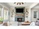 Inviting living room with a cozy fireplace, built-in shelving, and ample natural light, creating a warm, welcoming atmosphere at 906 Bingham St, Woodstock, GA 30188