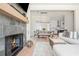 Open-concept living space with a fireplace, a view of the dining area and kitchen, and hardwood floors, perfect for gatherings at 906 Bingham St, Woodstock, GA 30188