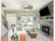Bright and airy living room with a fireplace, white sectional, and large windows for natural light at 906 Bingham St, Woodstock, GA 30188