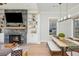 Inviting living room features a tiled fireplace, built-in shelving, and a seamless flow into the dining area at 906 Bingham St, Woodstock, GA 30188