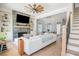 Stylish living room with a stone fireplace, built-in shelves, and a modern ceiling fan, creating a cozy atmosphere at 906 Bingham St, Woodstock, GA 30188