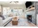 Bright living room featuring a modern fireplace, a comfortable sofa, and large windows, ideal for relaxation and entertainment at 906 Bingham St, Woodstock, GA 30188