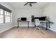 Bright home office featuring a ceiling fan, natural light, and modern minimalist decor at 906 Bingham St, Woodstock, GA 30188