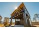 Modern outdoor stage with wood ceiling, stage lights, and gray paint at 906 Bingham St, Woodstock, GA 30188