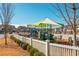 Community playground with slides and climbing structures, surrounded by green space and Gathering-friendly amenities at 906 Bingham St, Woodstock, GA 30188