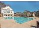 Community pool surrounded by a large pool deck with clubhouse at 906 Bingham St, Woodstock, GA 30188