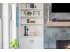 Built-in shelving showcases decorative items alongside the fireplace for both storage and style at 906 Bingham St, Woodstock, GA 30188