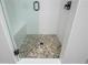 Walk in shower featuring pebble floor and built in bench at 906 Bingham St, Woodstock, GA 30188