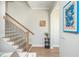 Staircase with wooden steps and black railings, accented by stylish artwork on the wall at 906 Bingham St, Woodstock, GA 30188