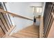 Elegant staircase showcasing light wood steps with modern black metal railing and natural light at 906 Bingham St, Woodstock, GA 30188